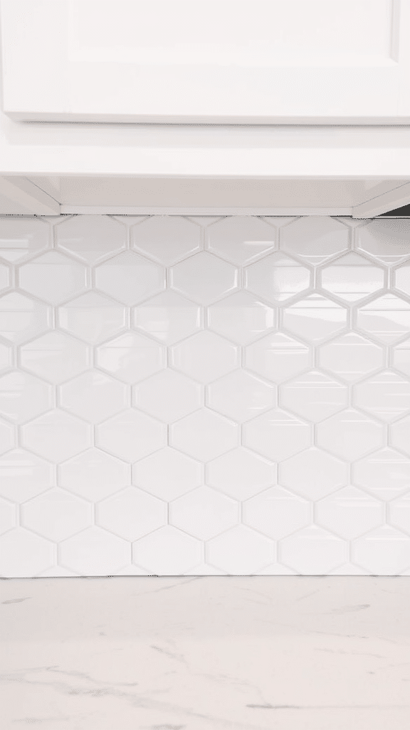 Hexagonal white subway tiles on a kitchen backsplash