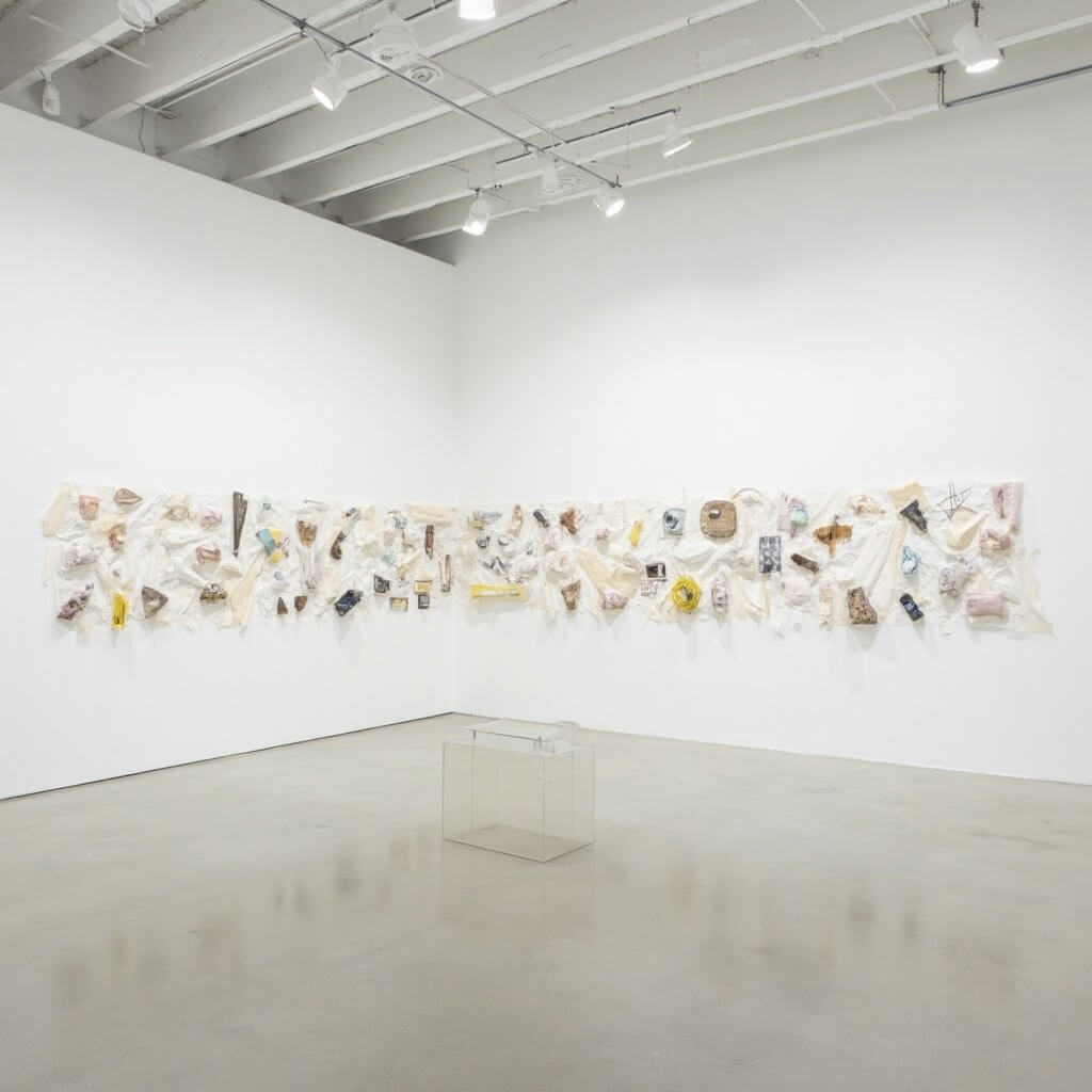 Abstract contemporary art installation featuring geometric shapes and multimedia artwork on a large wall in the minimalist, white gallery space of SITE Santa Fe, illuminated by clean modern lighting, no people present, evoking artistic innovation and experimentation.